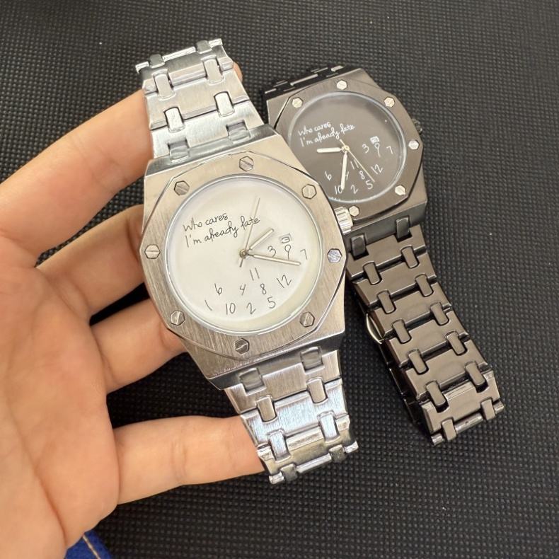 Two OCTON Steel watches held in hand, silver and charcoal